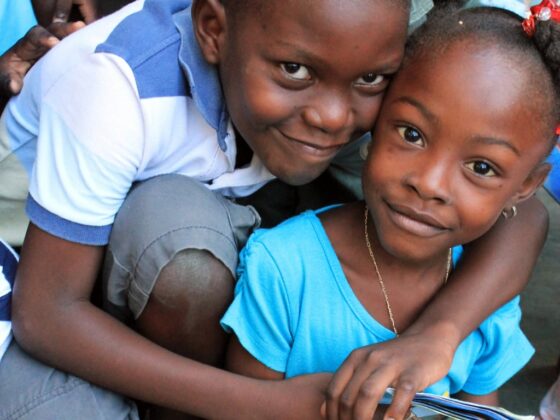 two children embrace in Haiti