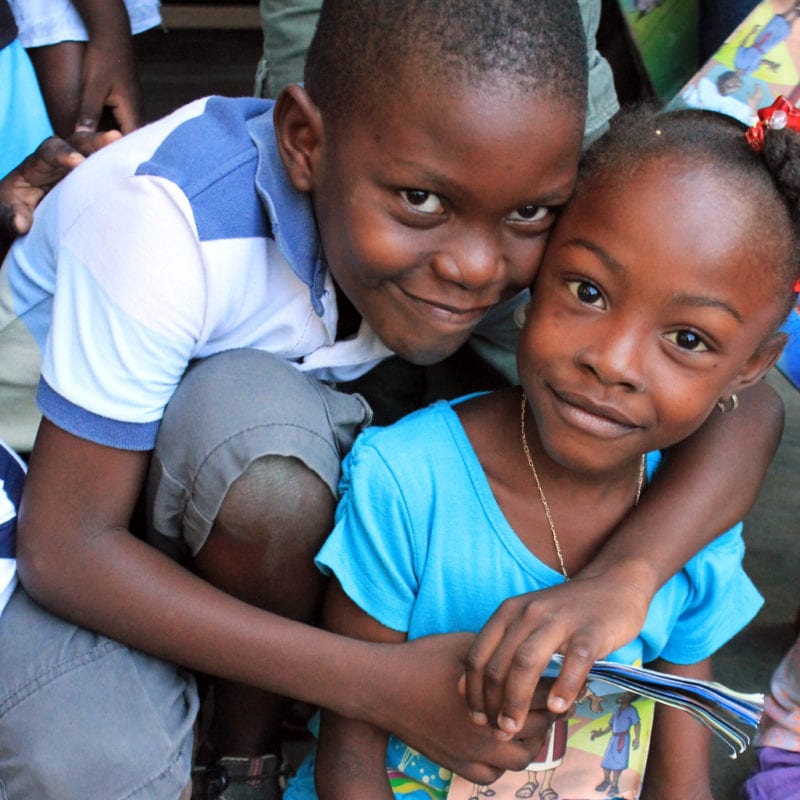 two children embrace in Haiti