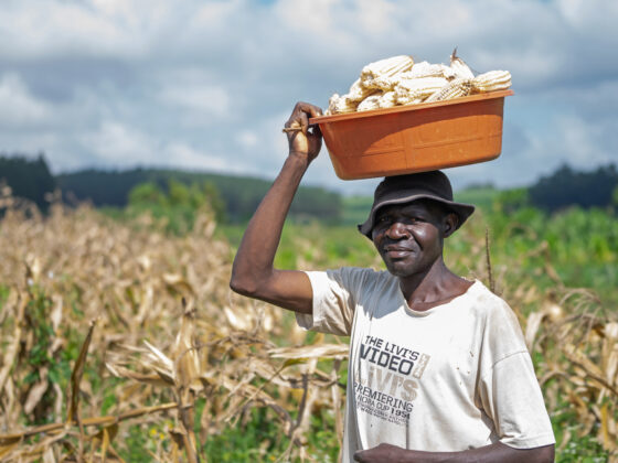 Michael planting corn for farming in Uganda